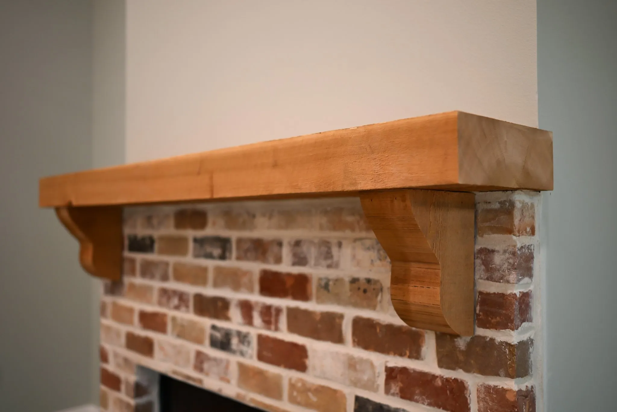 Precision millwork timber mantel fabricated by Alvarez Construction